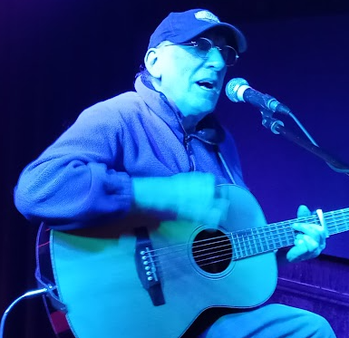 John Fryer playing guitar and singing